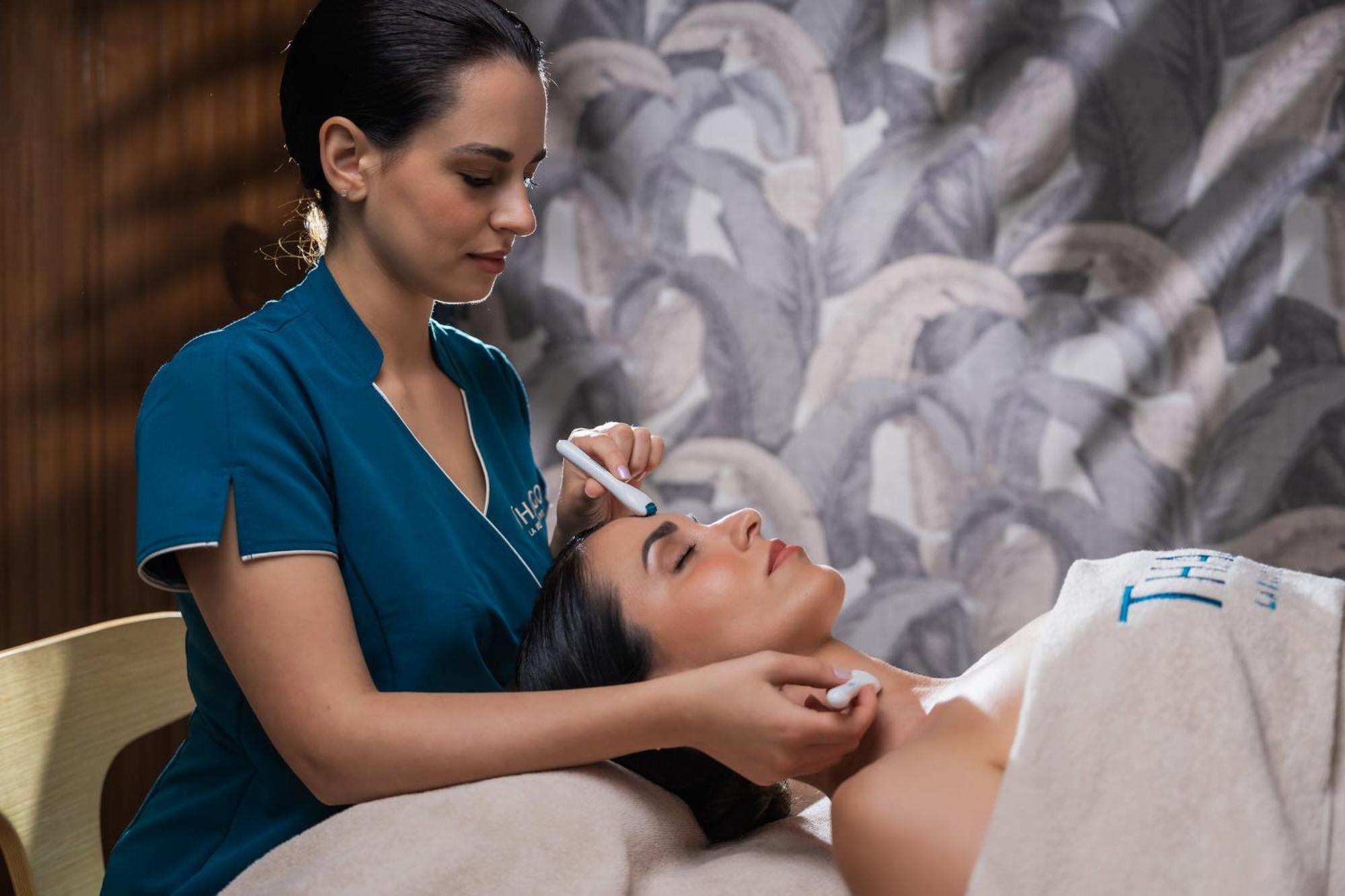 Hilton Rijeka Costabella Beach Resort And Spa Exterior photo A woman receiving a facial treatment